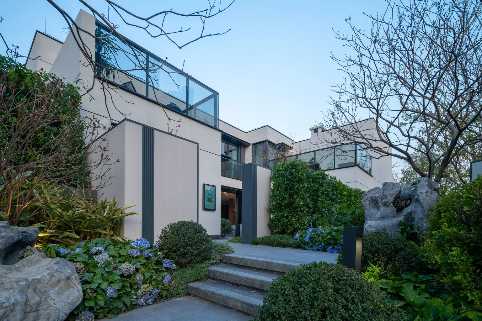 Malaysian courtyard villa with framed windows and stone façade