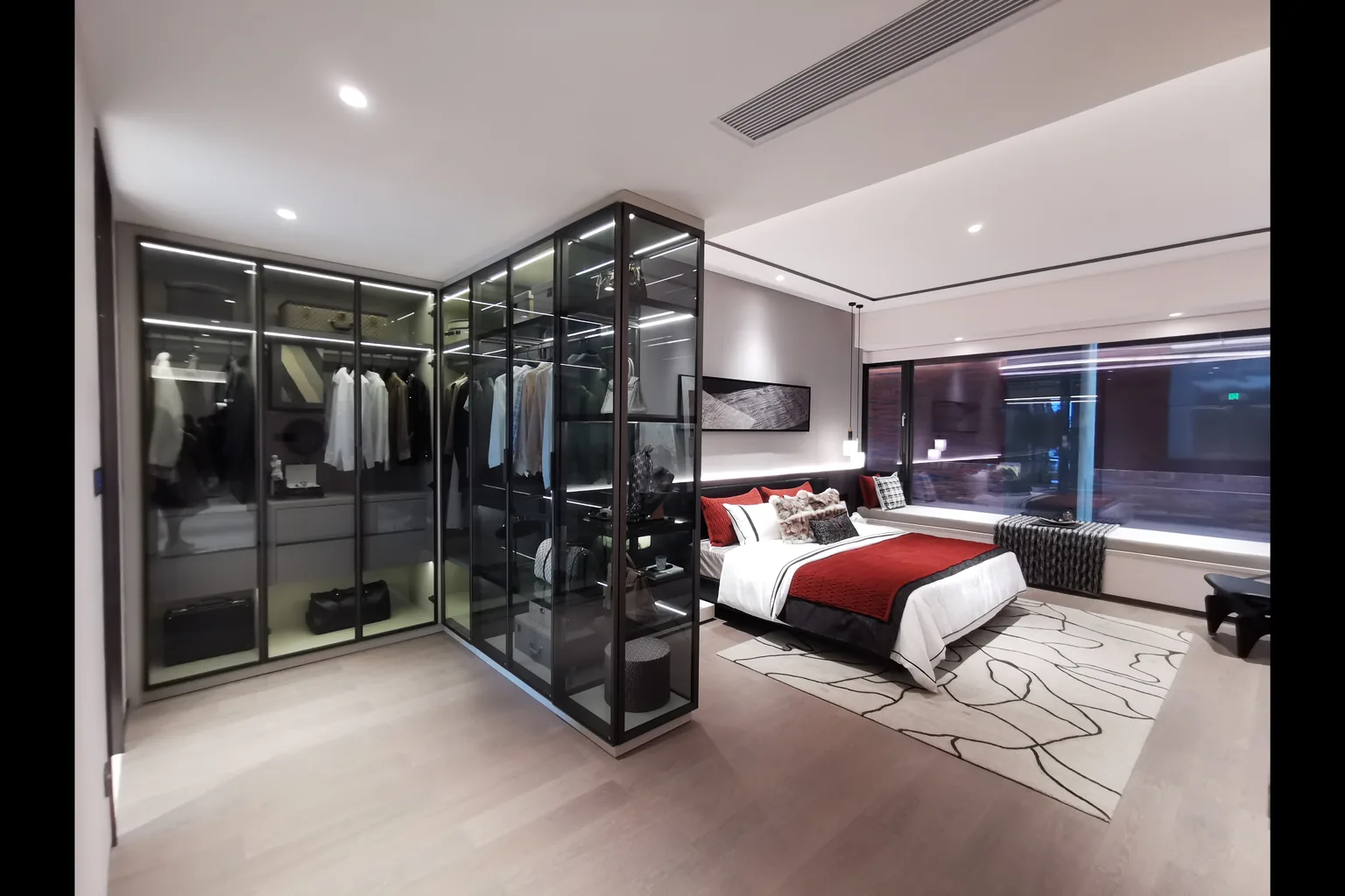 Master bedroom with glass-front wardrobe, upholstered bed and wide windows