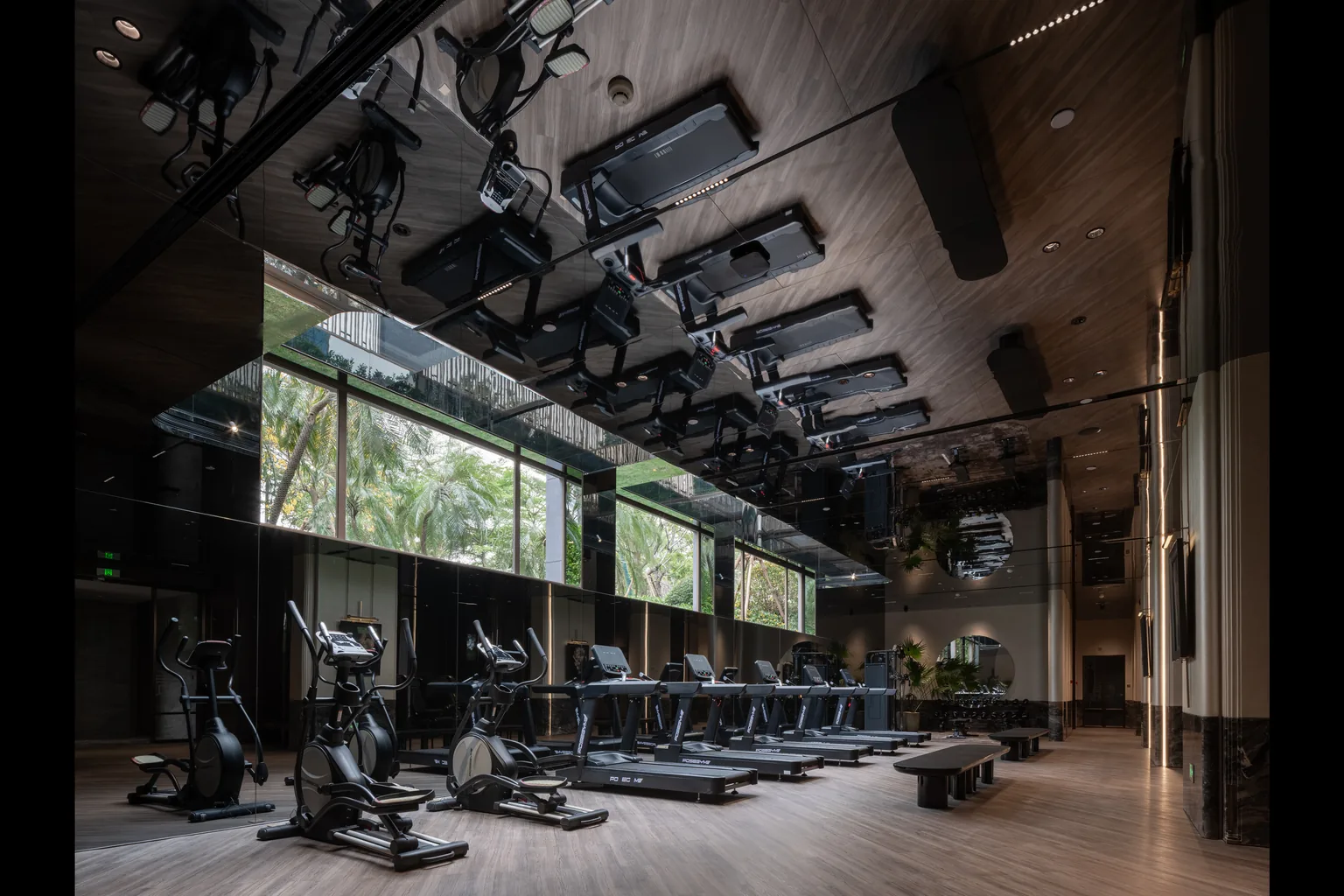 United Kingdom gym equipment floor with mirrored ceiling and courtyard glazing