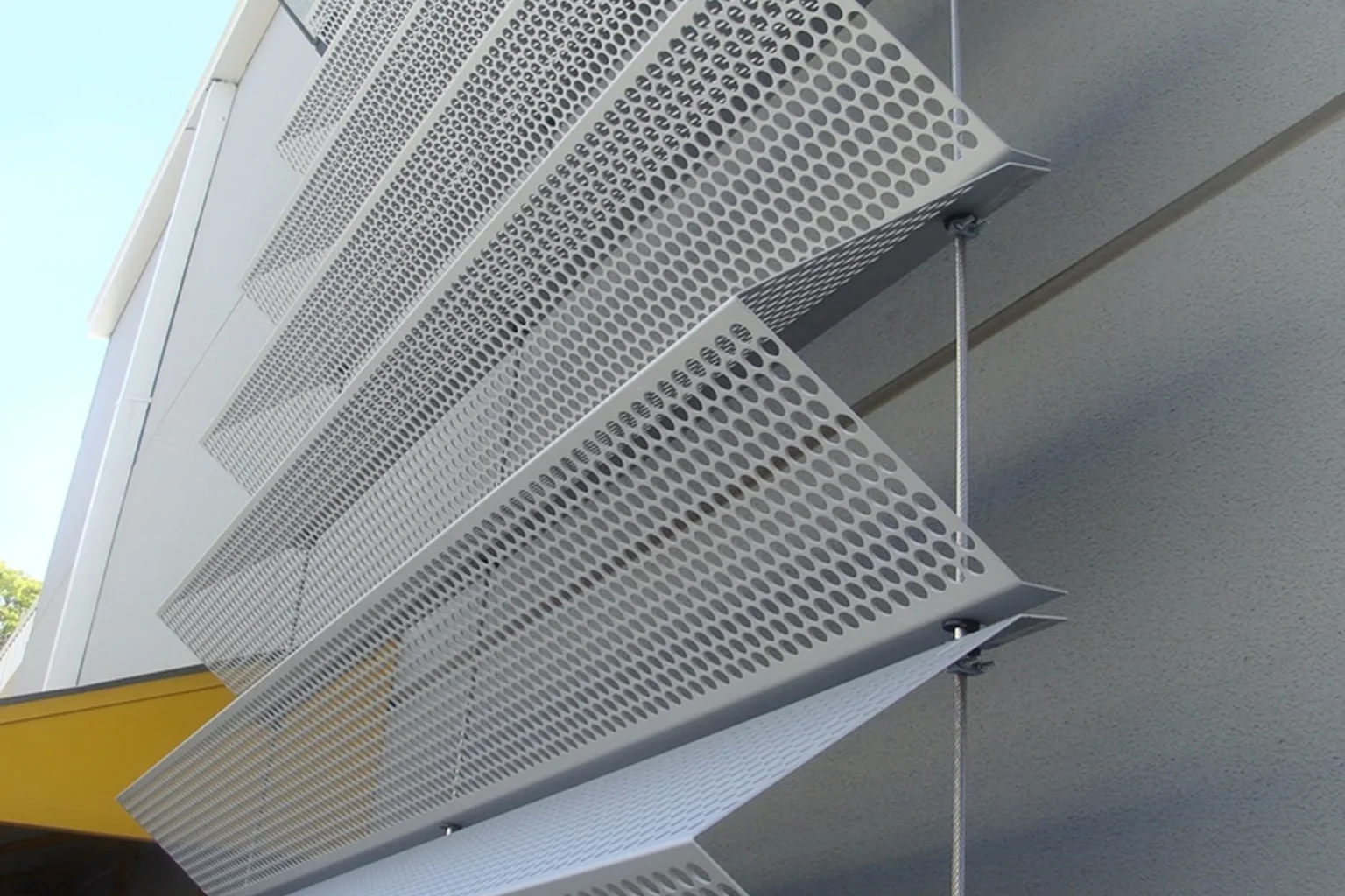 Building exterior with shaped aluminum cladding panels