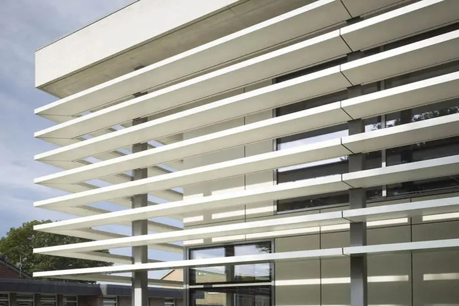 Architectural aluminum louvers creating shade and façade rhythm