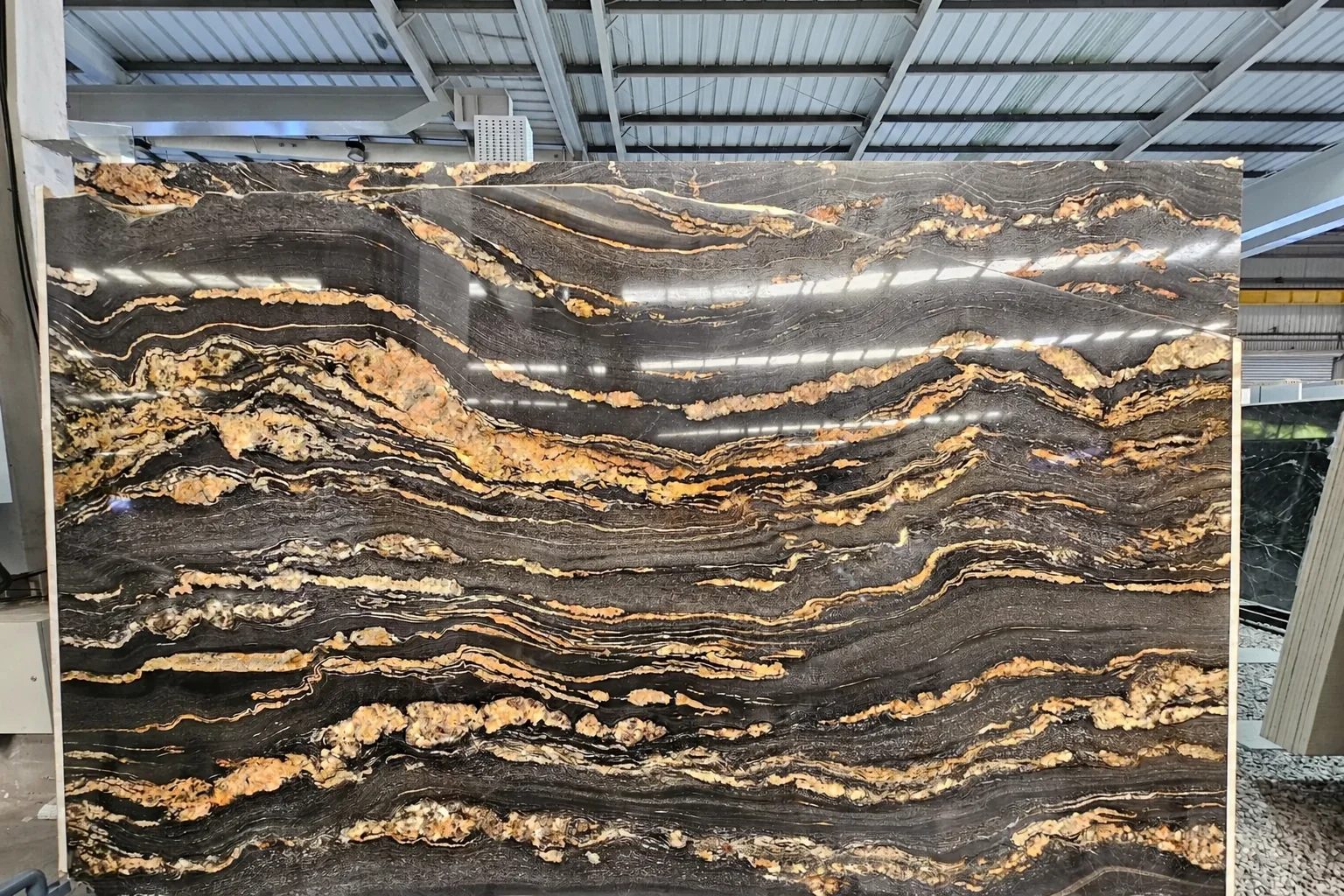 Dark natural stone slab with dramatic gold veining