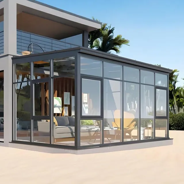 Dark aluminum sunroom with coordinated wall and roof glazing beside a modern villa