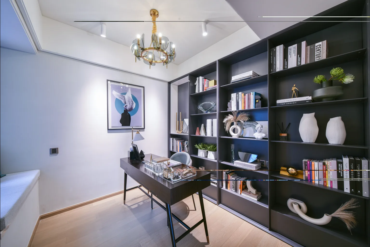 Study with built-in bookcase, desk and chandelier