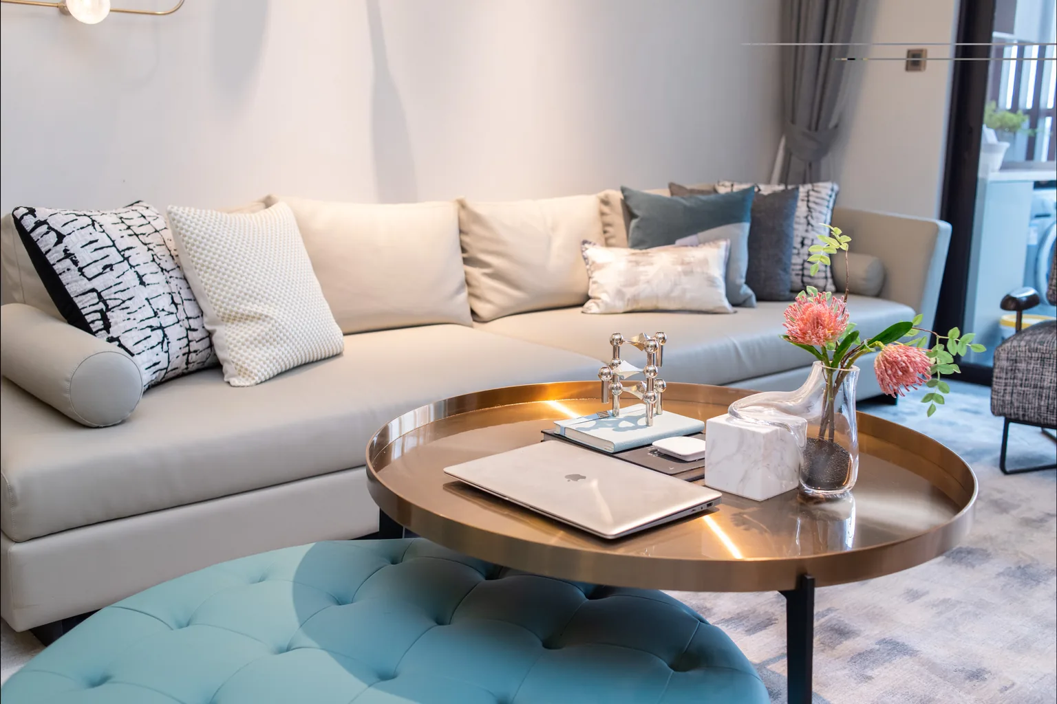 Refurbished living room with curved sofa, marble coffee table and patterned floor tiles