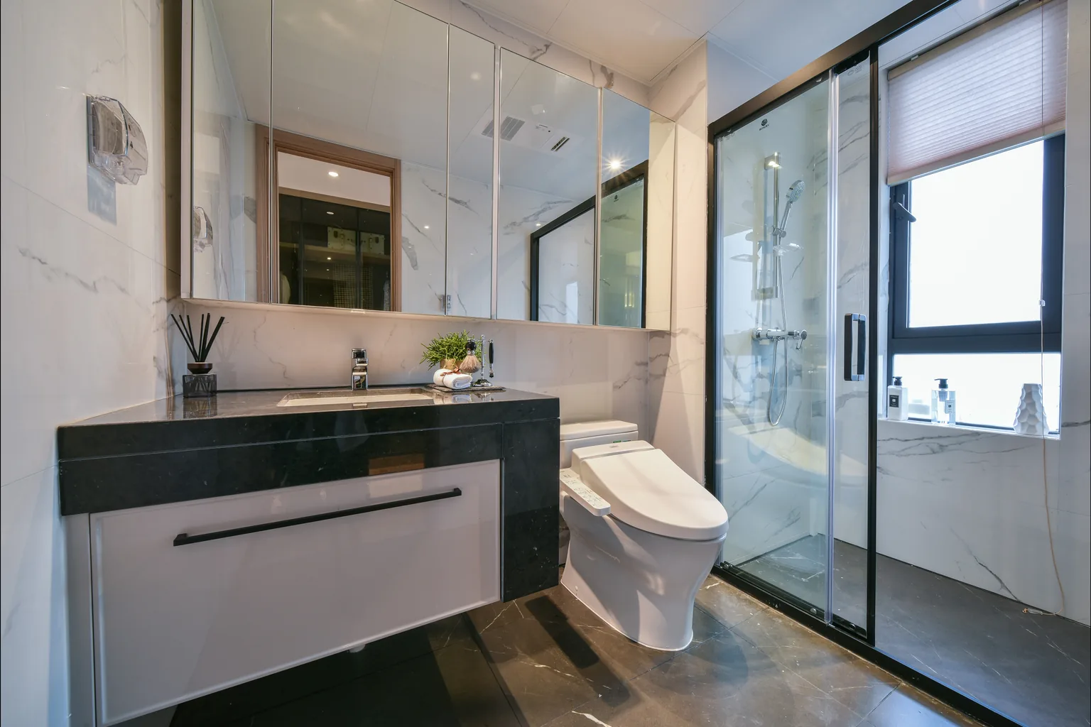 Bristol renovated bathroom with stone finishes and glass shower