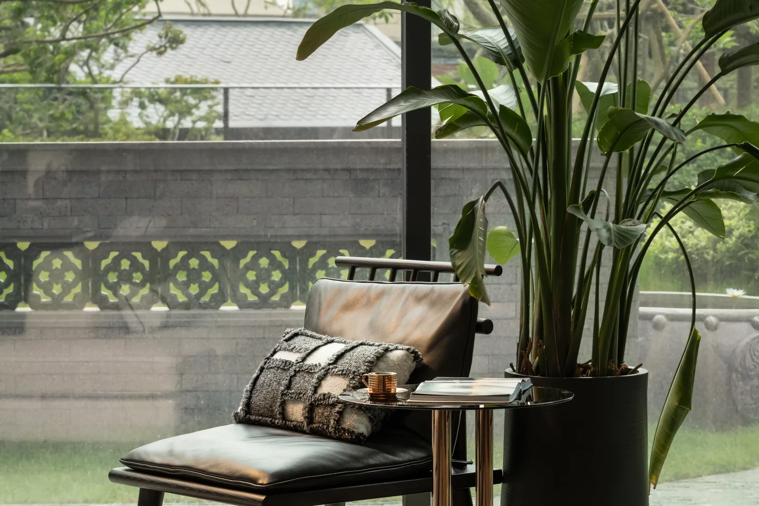 Penang villa interior overlooking a landscaped courtyard through full-height glazing